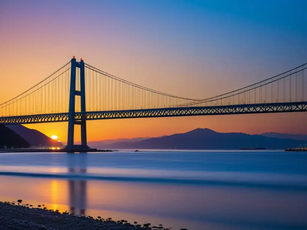 El puente Akashi Kaikyo destaca majestuosamente en un vibrante atardecer, mostrando detalle arquitectónico y la dinámica de fluidos en puentes